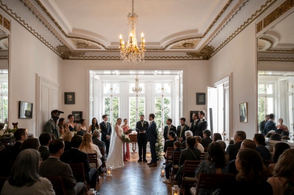 Bride groom guests seated and celebrant at alter during ceremony